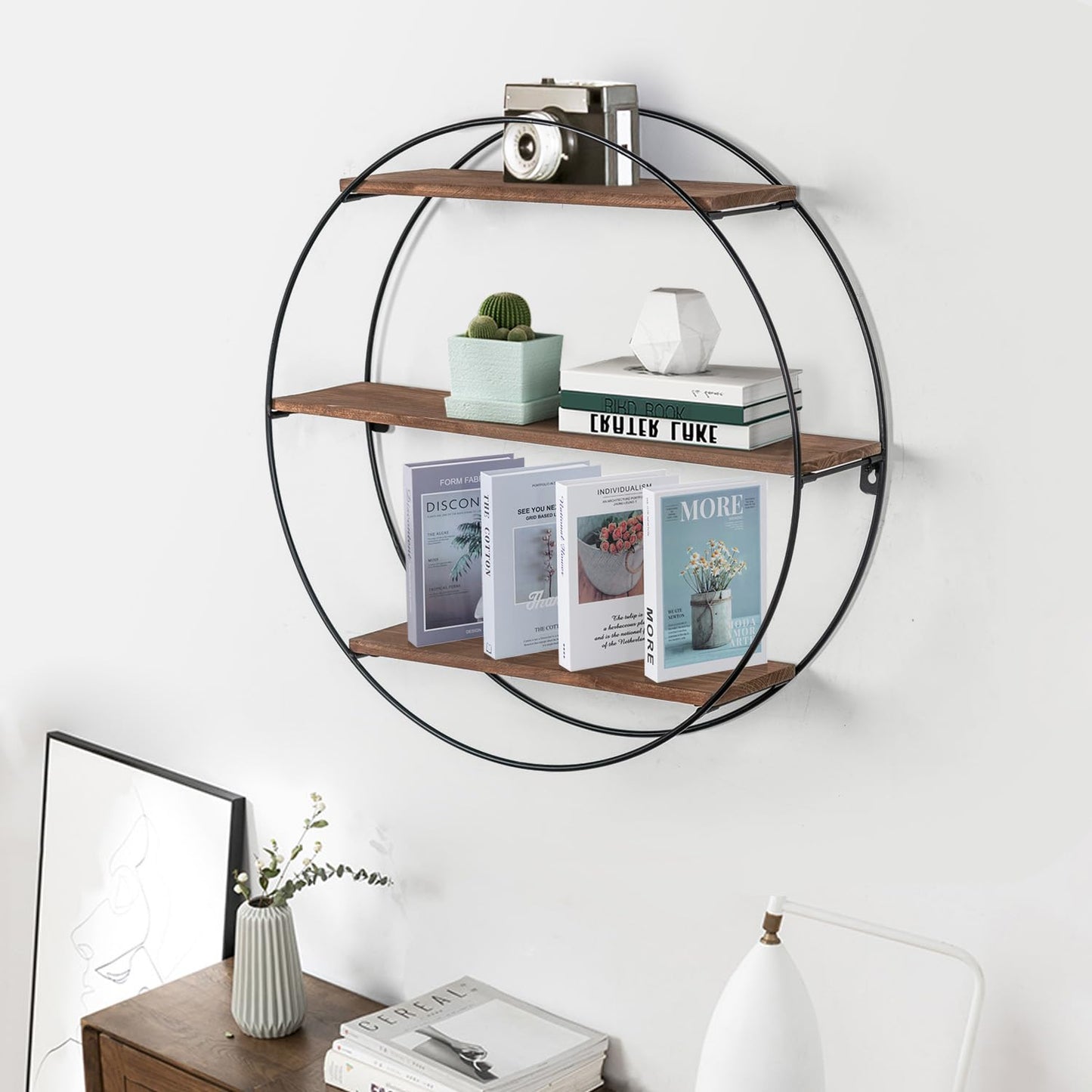 Round wall shelf with books and decor items on a white wall