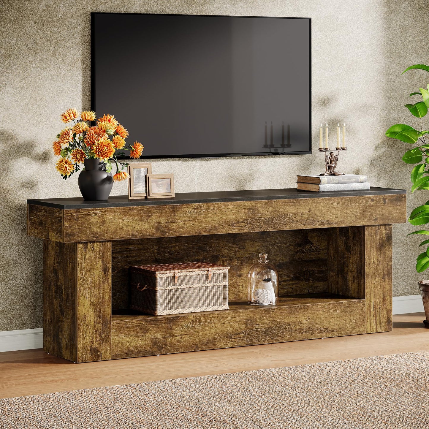 Wooden TV stand with decorative items in a living room setting