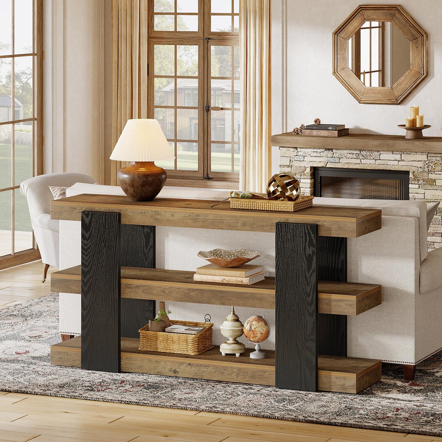 Wooden console table in a living room with decor items and a fireplace.
