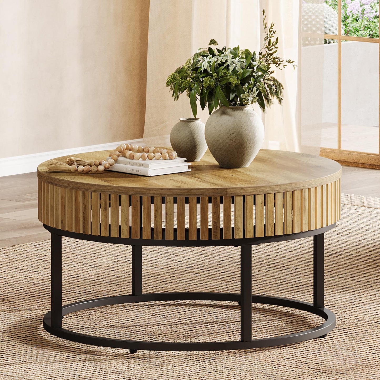 Round wooden coffee table with decorative items in a living room setting