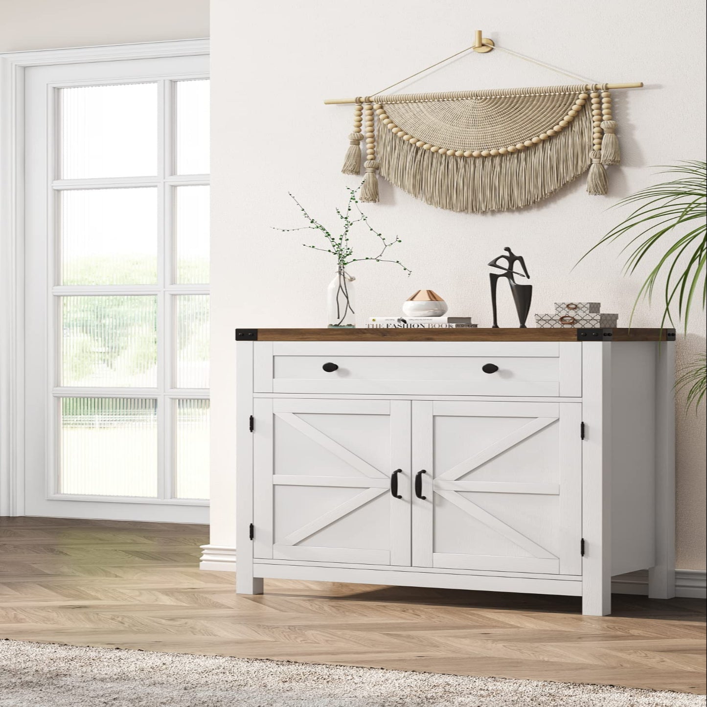White sideboard with wooden top in a room with large windows and decorative wall art.