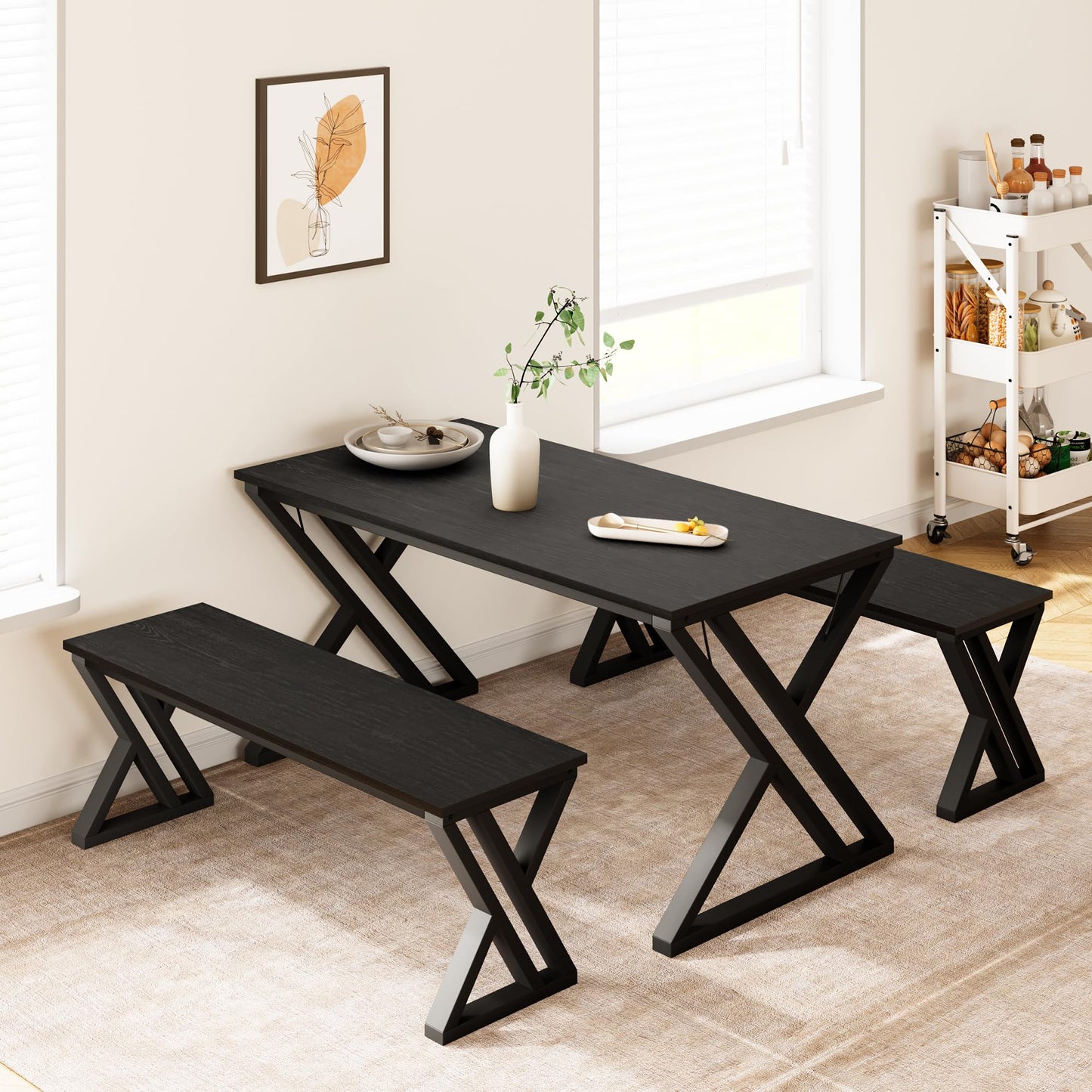 Black dining table with two benches in a bright room.