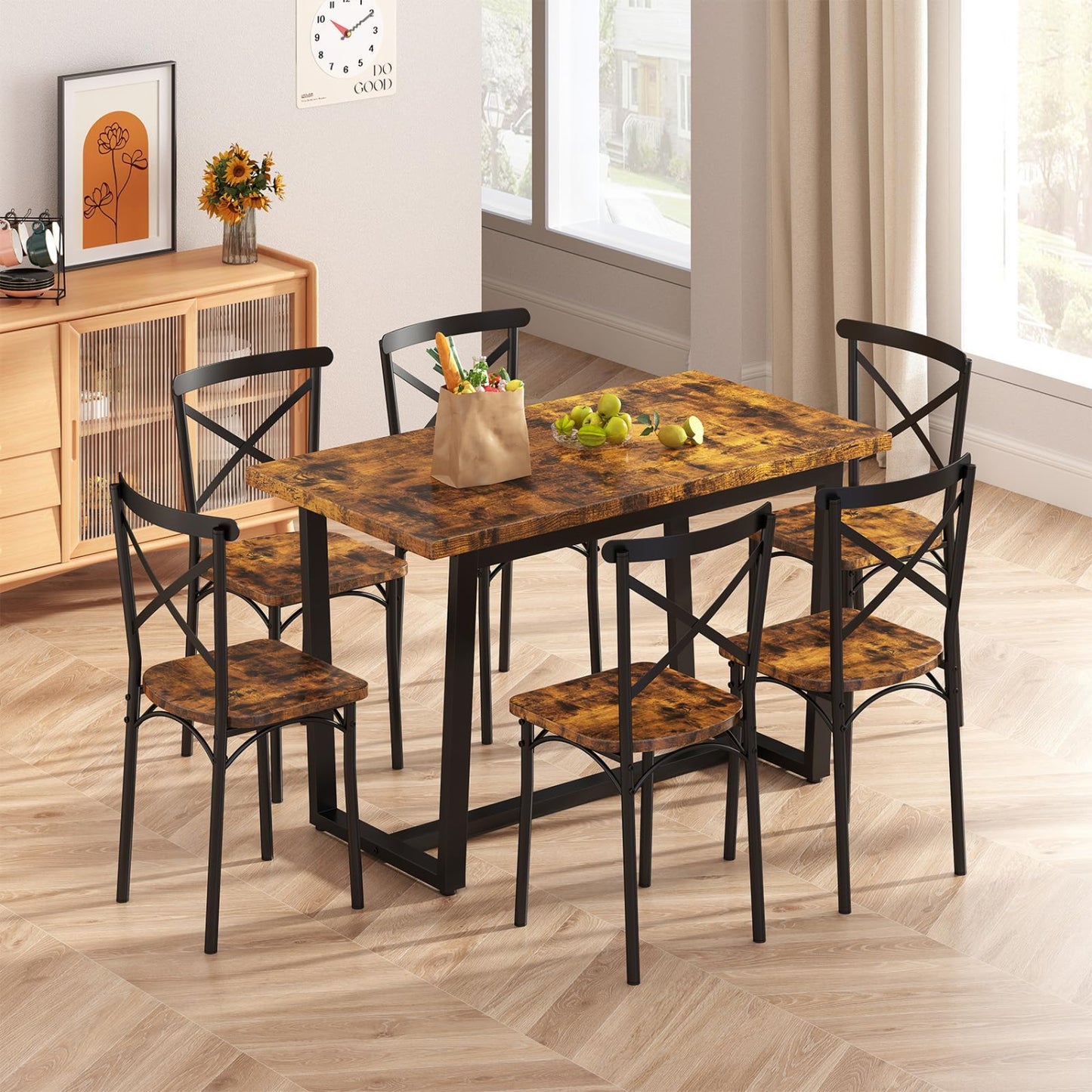 Dining table set with chairs in a room with a clock on the wall.