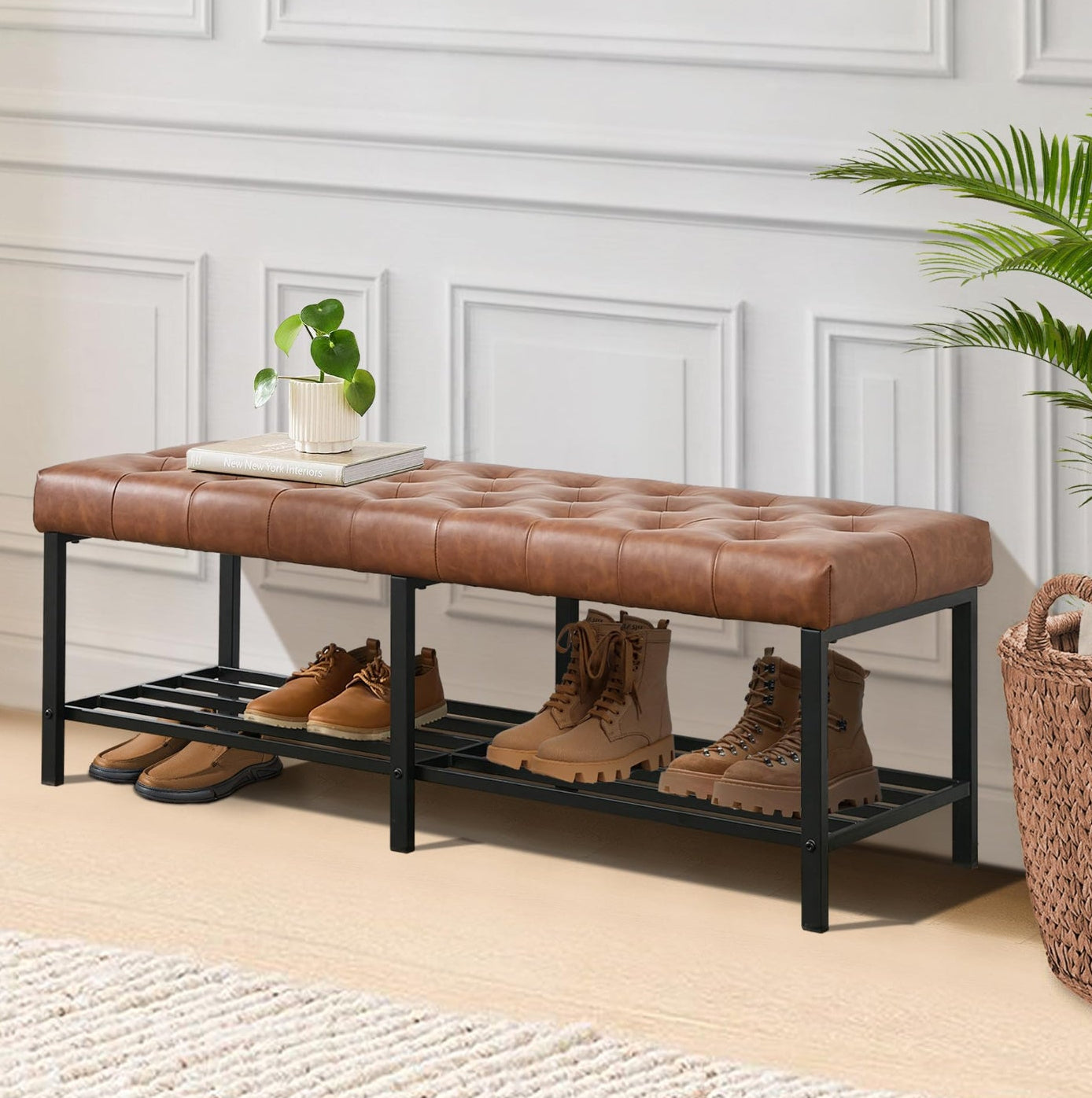 Brown leather bench with shoe rack against a white wall with decorative molding.