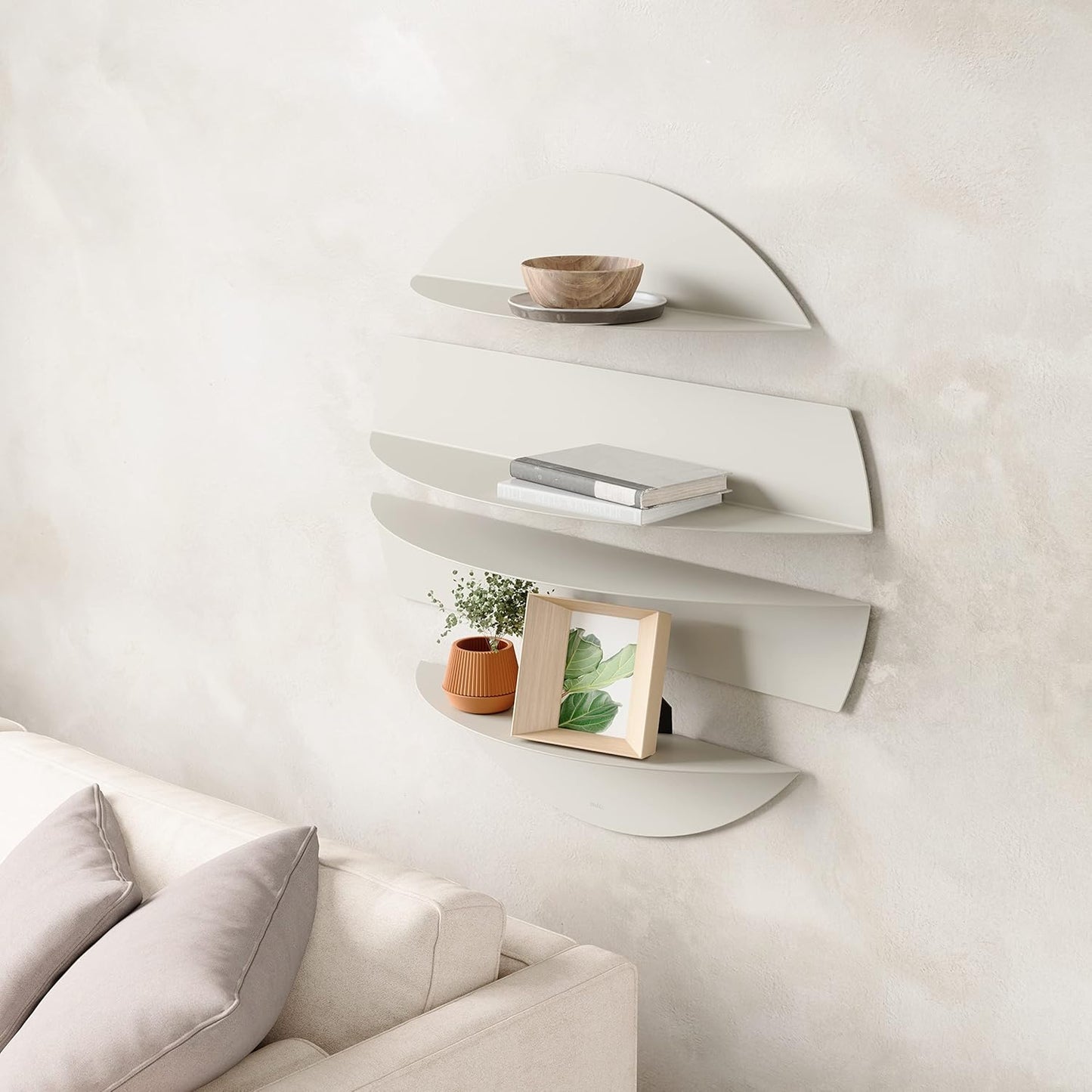 Wall-mounted shelves with decorative items in a minimalistic living room.