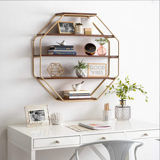 Geometric wall shelf with decorative items above a white desk.