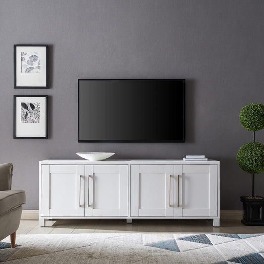 White entertainment console with a television mounted on a gray wall in a living room setting.