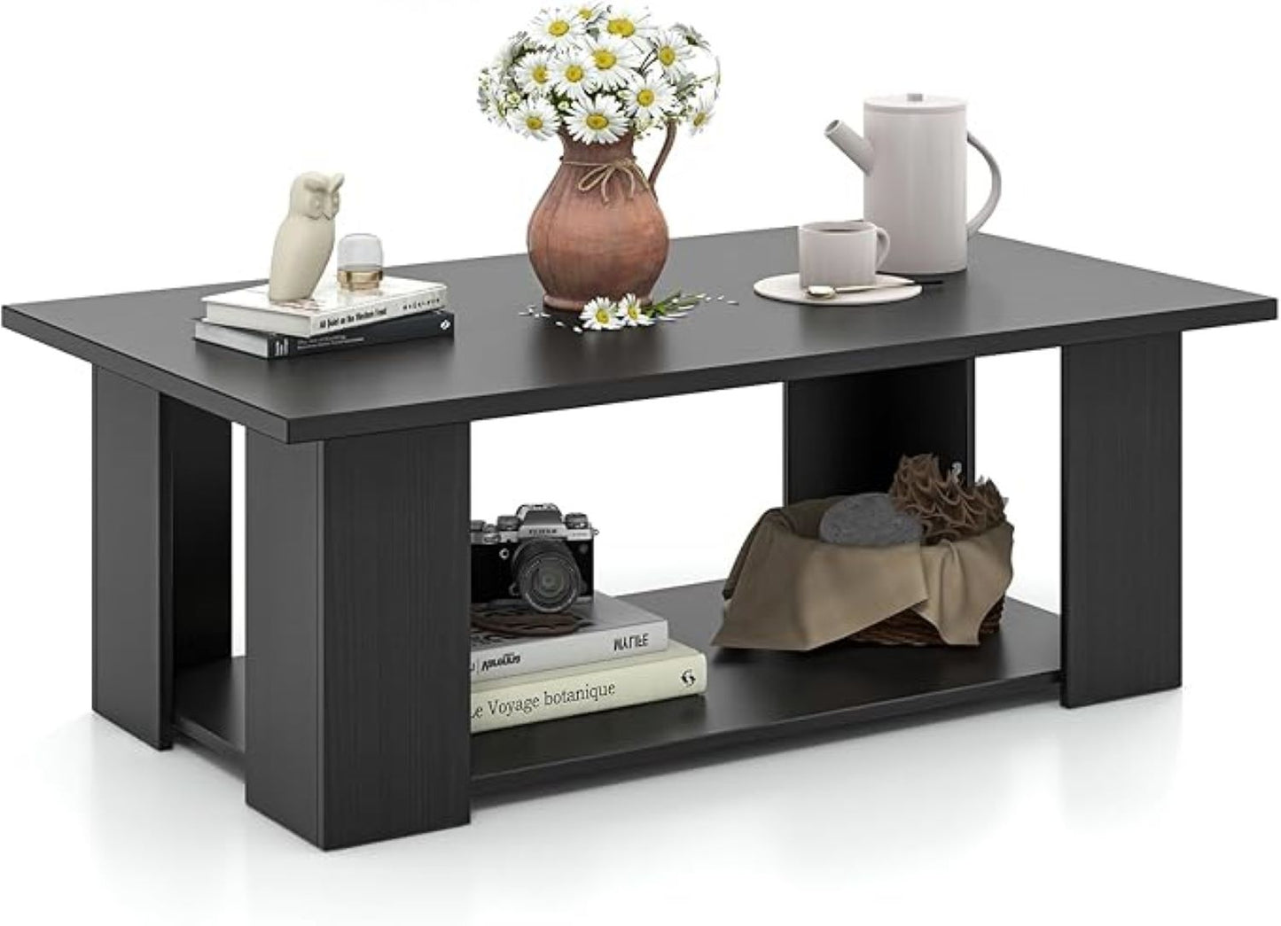 Black coffee table with decorative items on a white background
