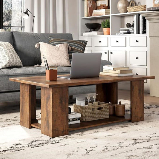 Wooden coffee table with a laptop and decorative items in a living room setting.