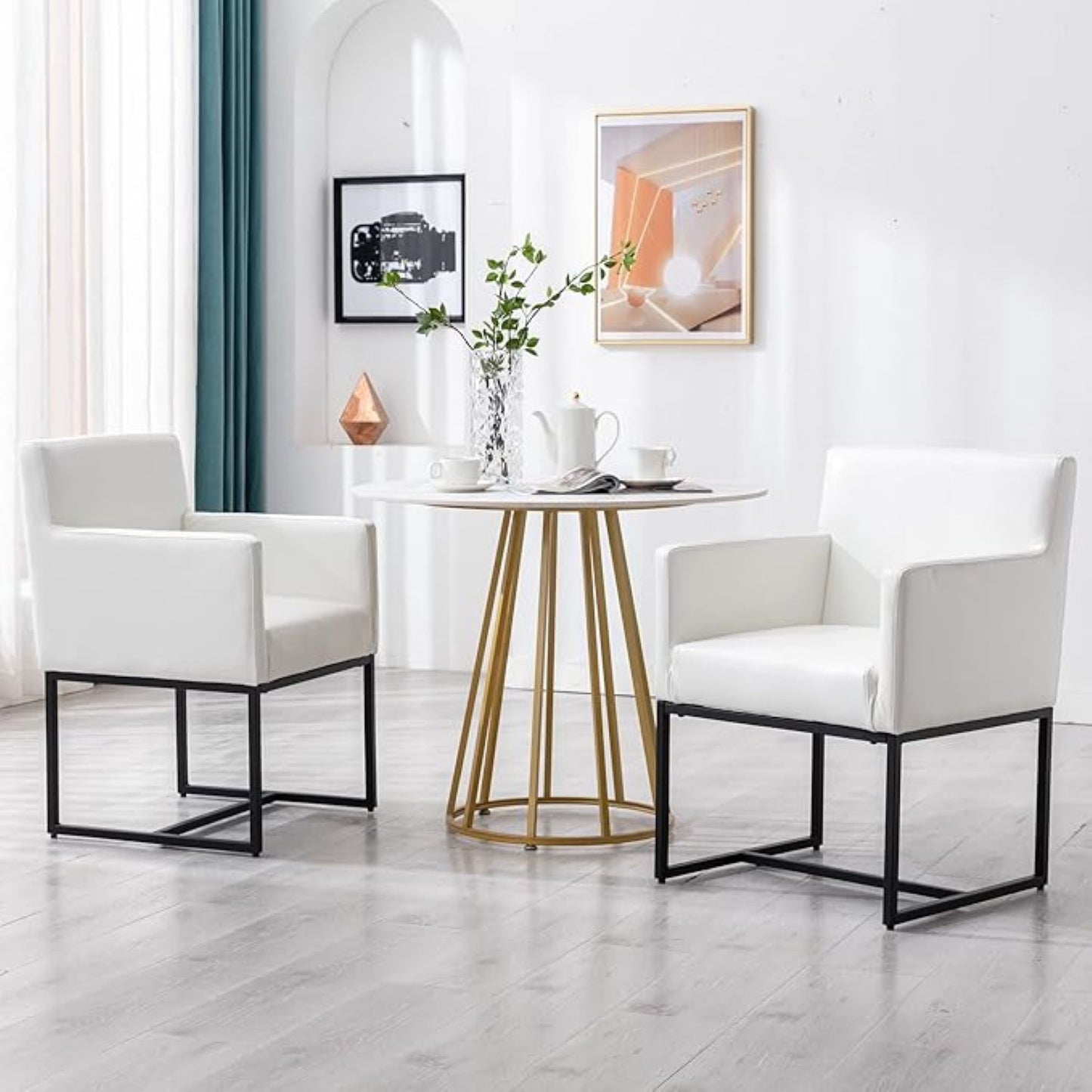 Modern living room with white chairs and a small round table.
