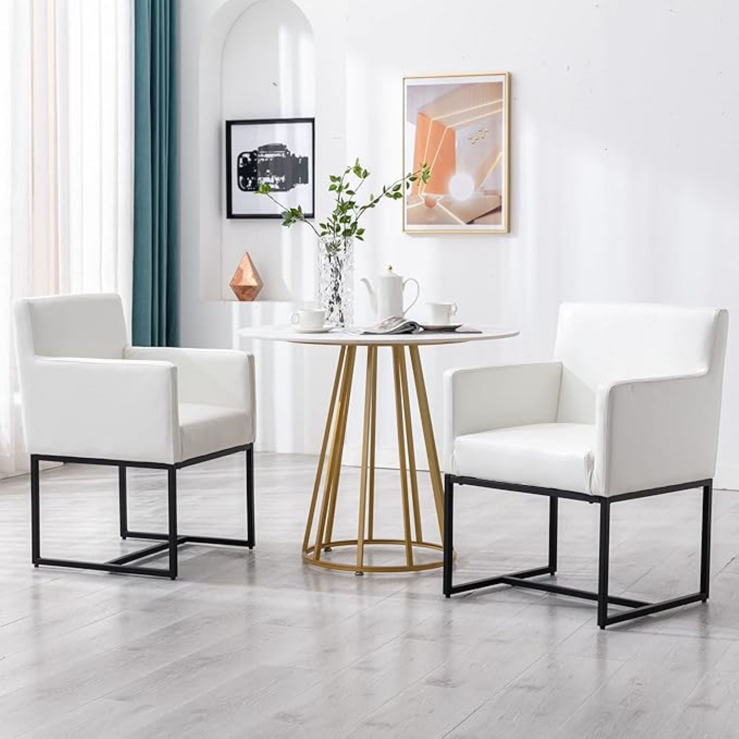 Modern living room with white chairs and a small round table.