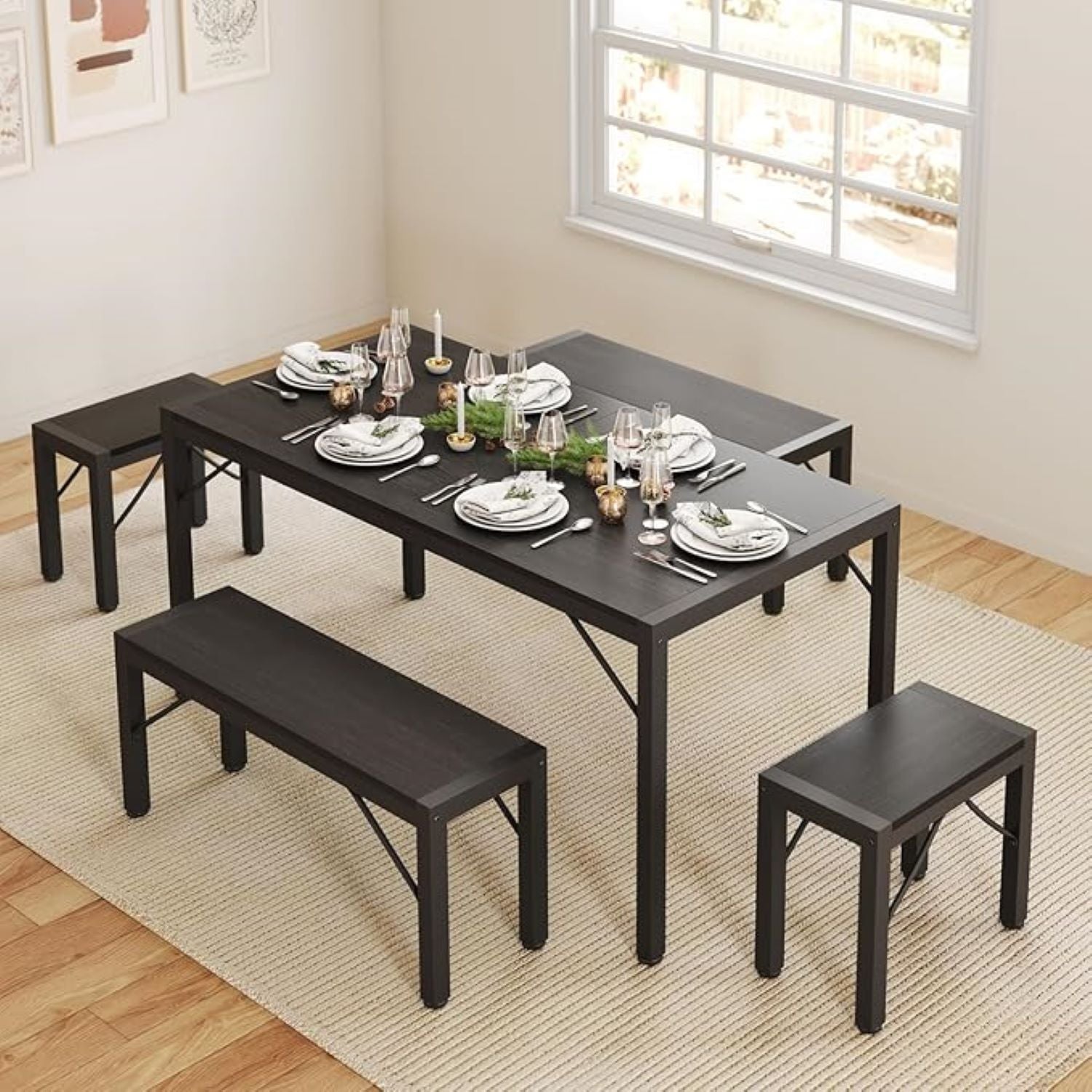Black dining table set with benches in a room with a window.