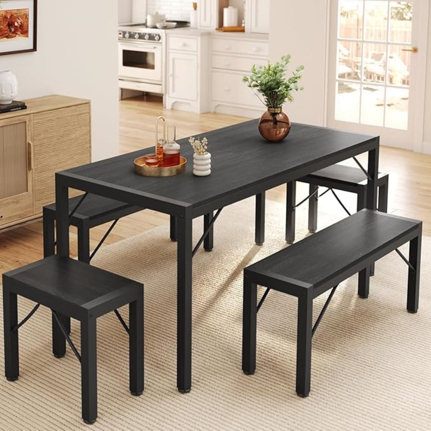 Black dining table set with chairs and a bench in a kitchen.