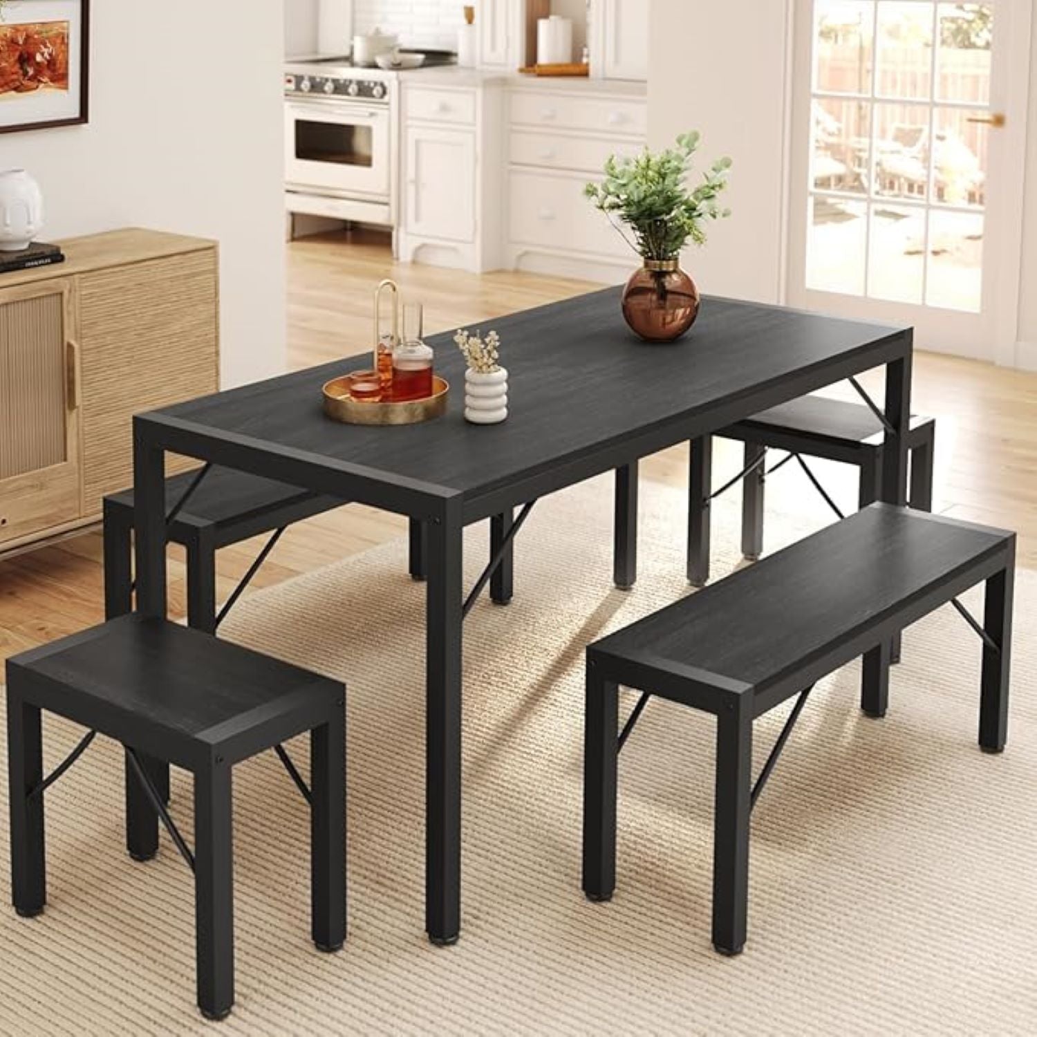 Black dining table set with chairs and a bench in a kitchen.