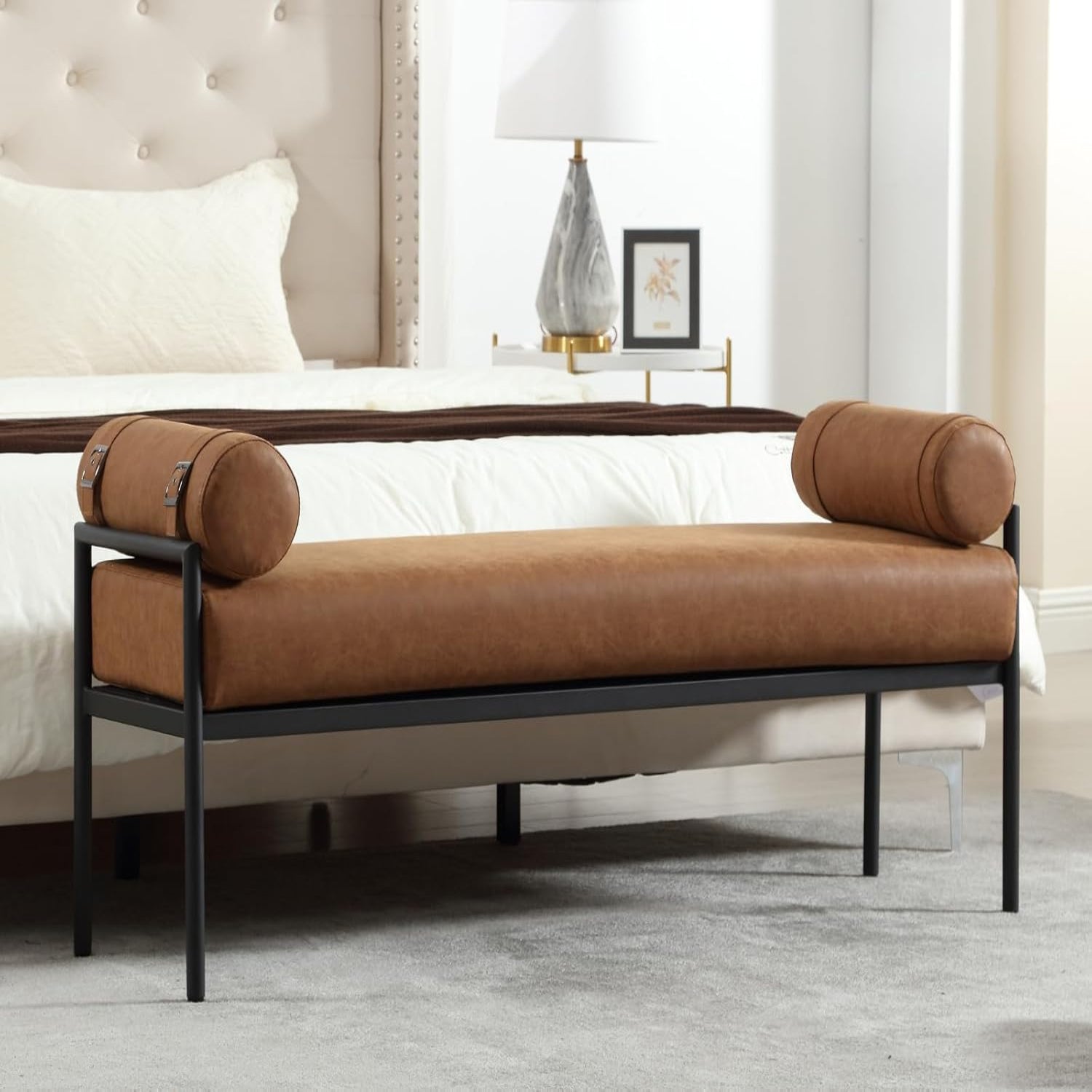 Brown bench with cylindrical cushions in a bedroom setting