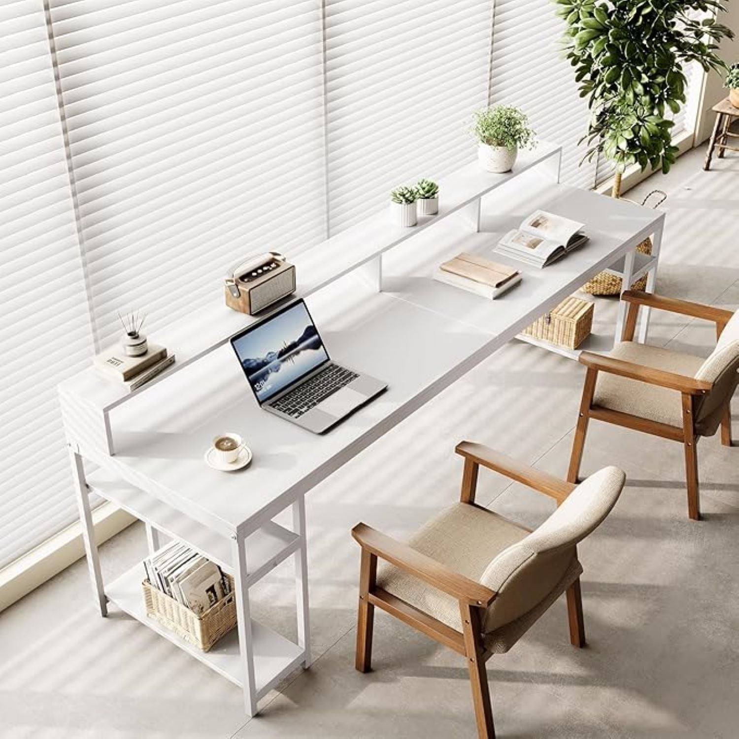 Modern home office with a white desk, laptop, and wooden chairs.