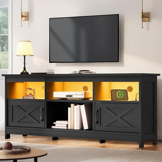 Black entertainment console with a TV mounted above it in a living room setting.