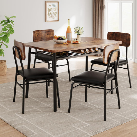 Dining table set with chairs in a room with a plant and framed picture on the wall.