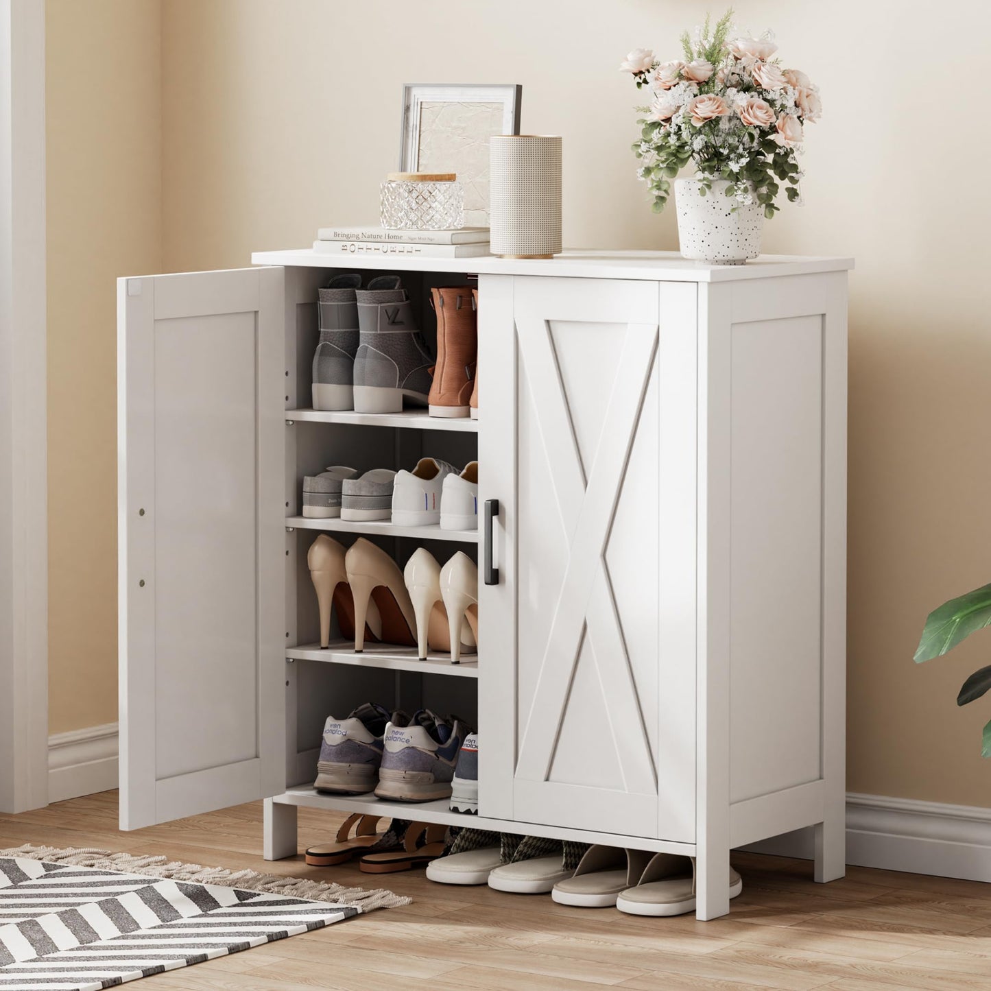 White shoe cabinet with open doors displaying shoes and decor items on a wooden floor.