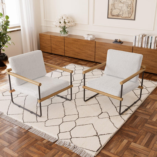 Two modern chairs with wooden frames on a geometric-patterned rug in a living room.