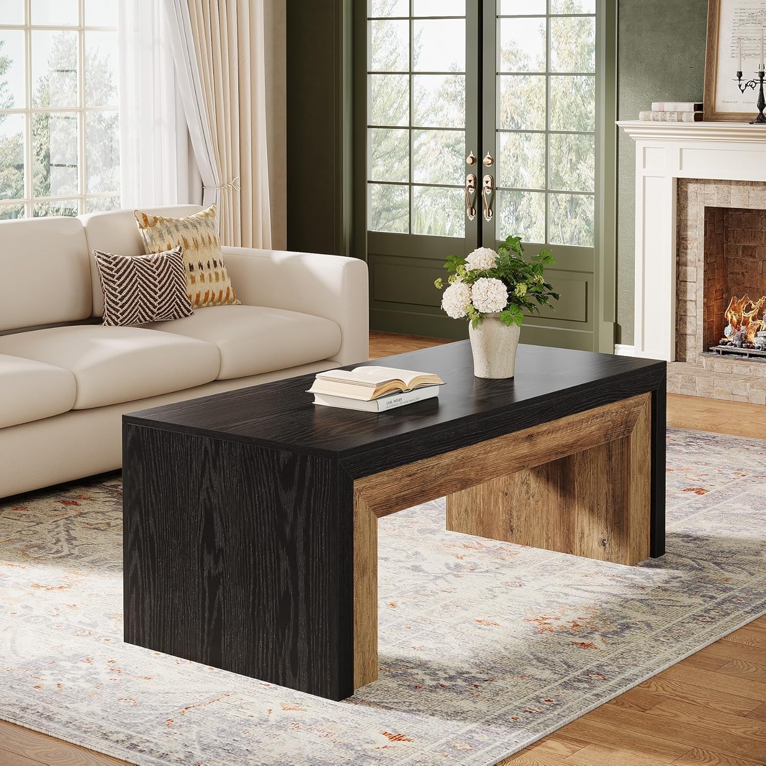Living room with a black and wood coffee table, beige sofa, and fireplace.