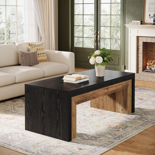 Living room with a black and wood coffee table, beige sofa, and fireplace.